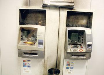 Eco-anarchists burn two HSBC bank ATMs