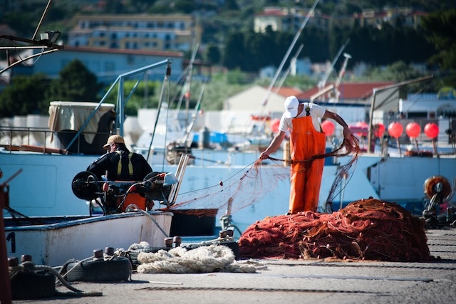 A sailor prepares to head out to sea with five 2.5-kilometer nets in ant'Agata di Militello, Sicily; 2.5 kilometers is the legal limit, but Mediterranean fishermen often join multiple nets of this size together to get around the law