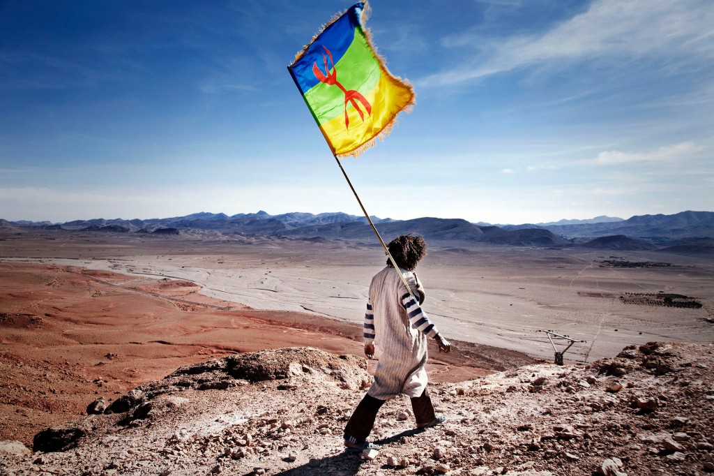 An activist with the Berber flag. Protesters have occupied a hilltop above a silver mine for more than two years.