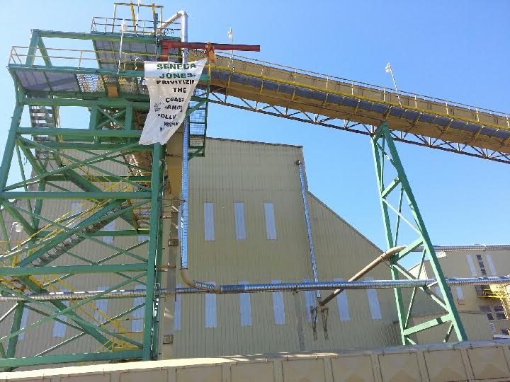 Banner reading: "Seneca Jones: Privatizing the Coast Lands, Polluting West Eugene" dropped at Seneca biomass facility in Eugene, OR.