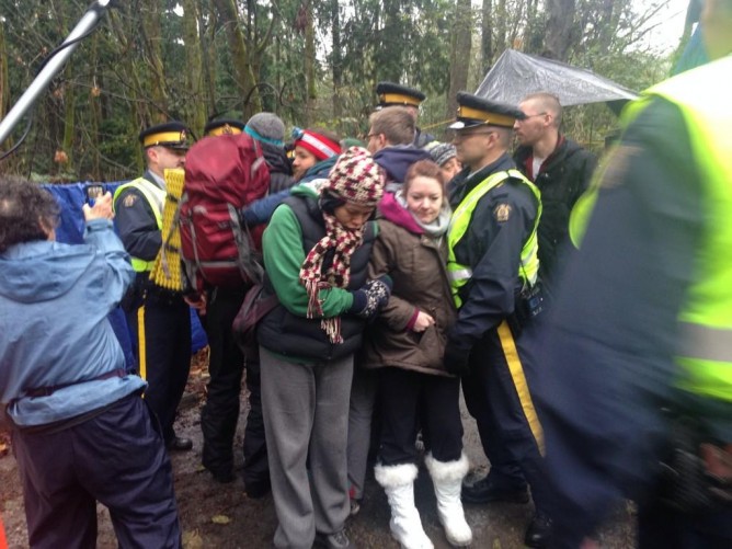 protestors lock arms as the police move in